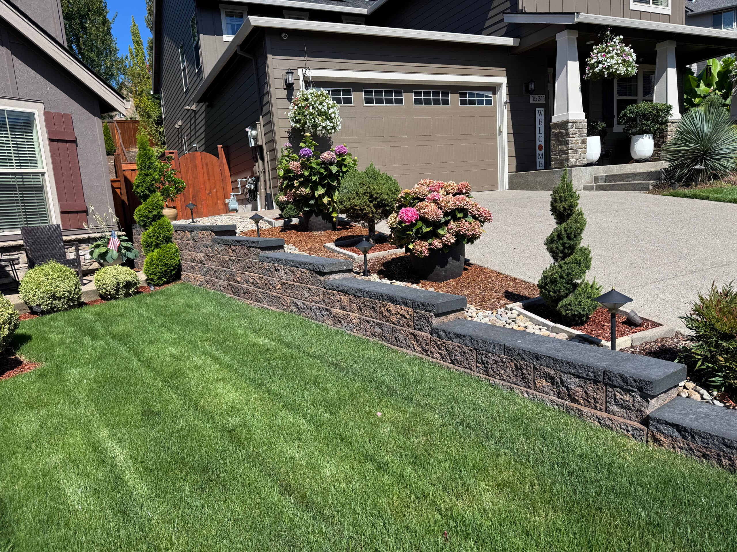 Segmental block retaining wall with new plantings — a GI Landscape install