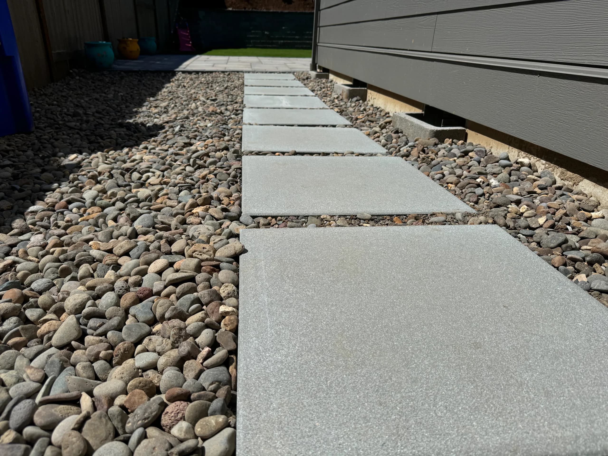 Modern stepping-stone paver walkway through artificial turf