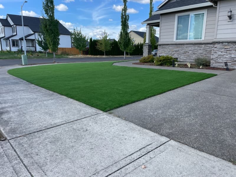Side-by-side cost comparison of a real grass lawn vs a GI Landscape artificial turf install